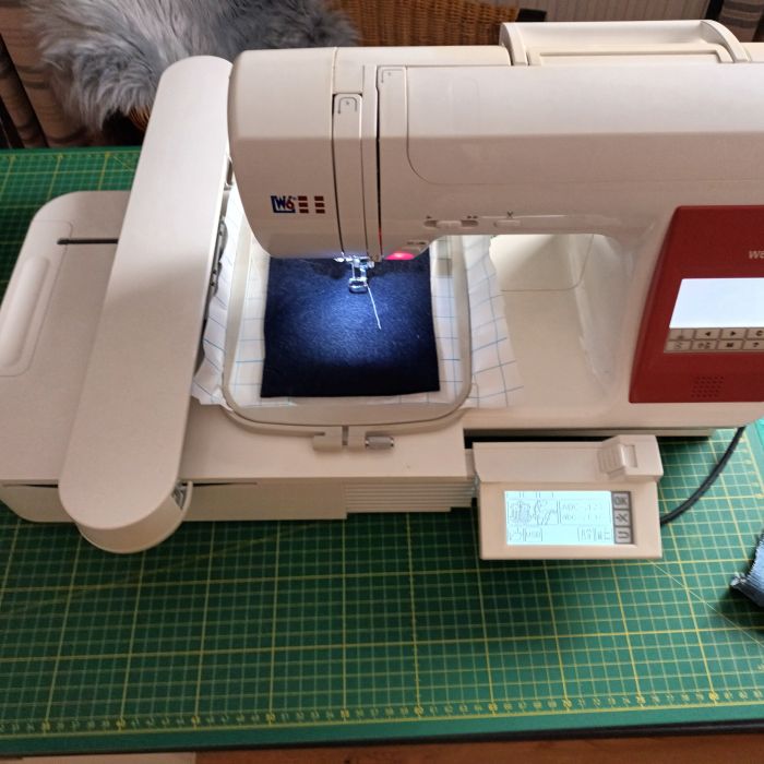 Stickmaschine in Aktion, während der Filz-Organizer bestickt wird.